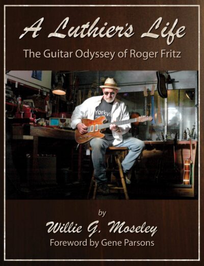 The cover of A Luthier's Life is a man sitting on a stool in a workshop playing an electric guitar